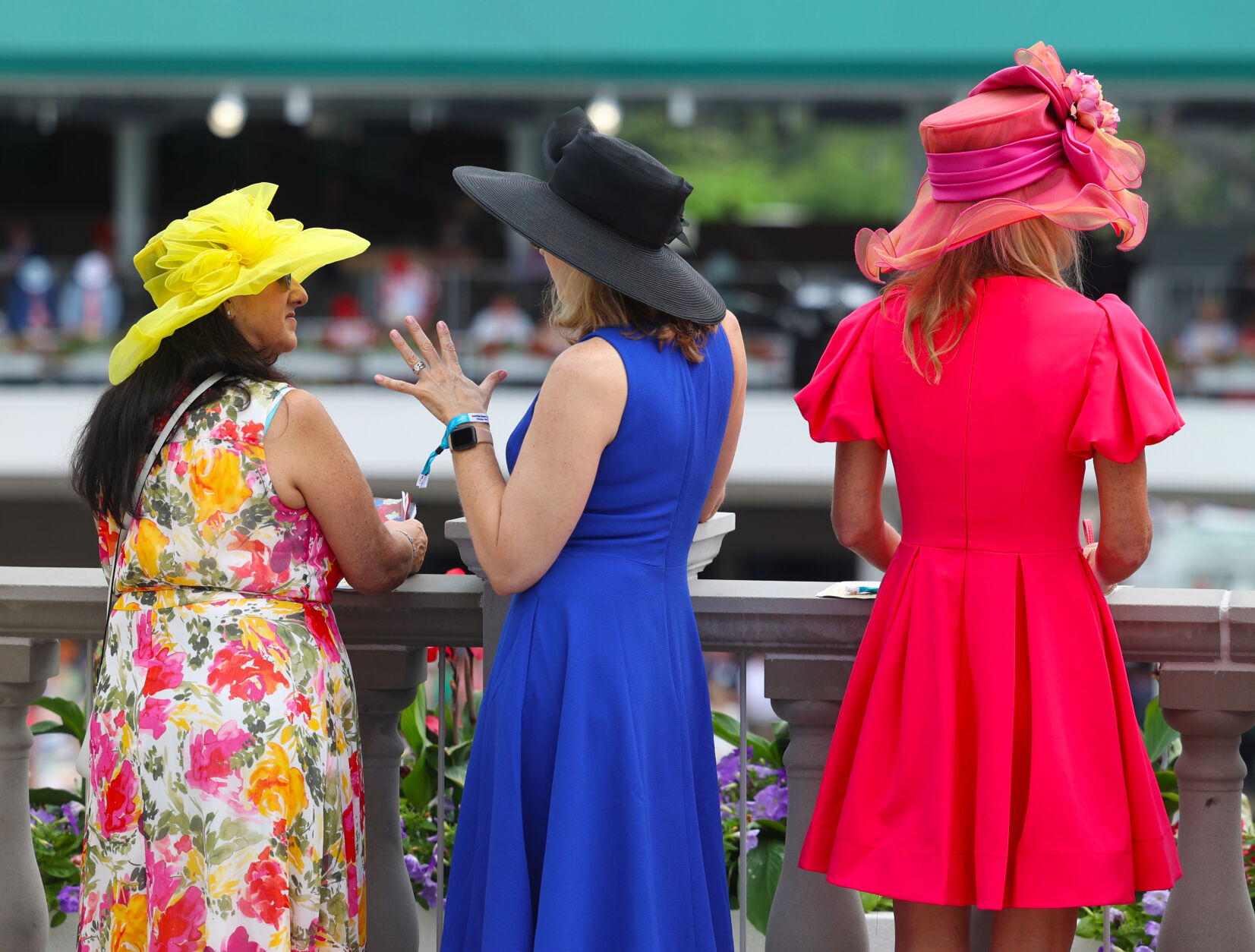 3 women look over Paddock at Churchill.JPG